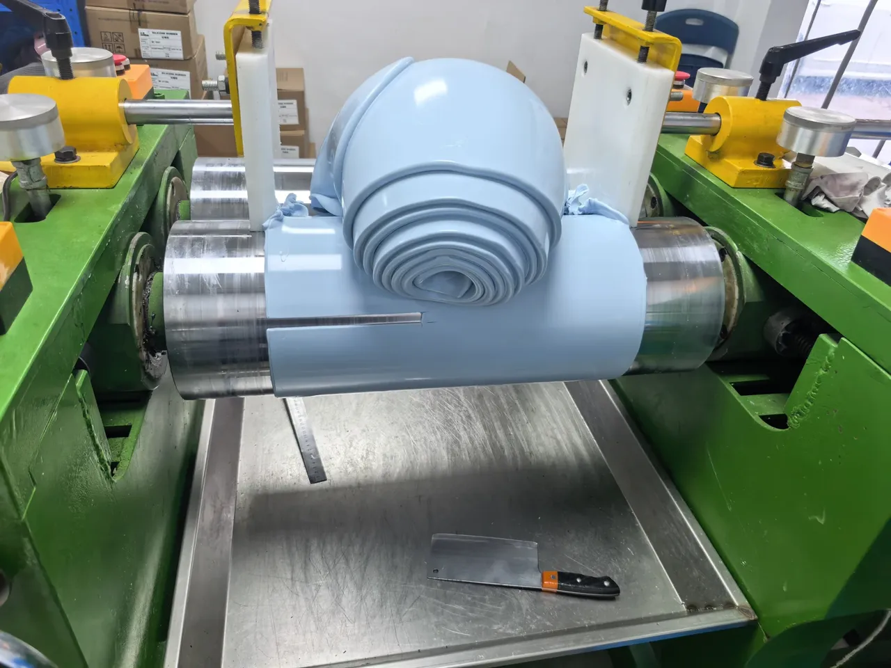 Blue-gray molding compound passing through a two-roll mixing machine