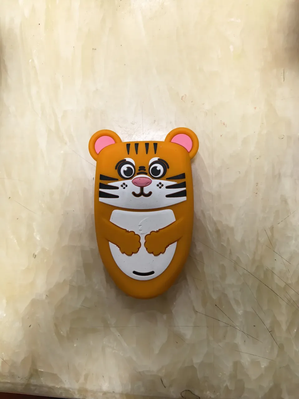 Tiger-shaped molded cover from the supplied product photographs