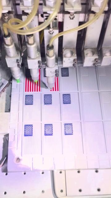 Colored material dispensed into a multi-cavity mold in the workshop